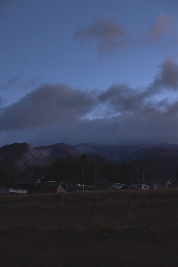 夕暮れの集落と山並み